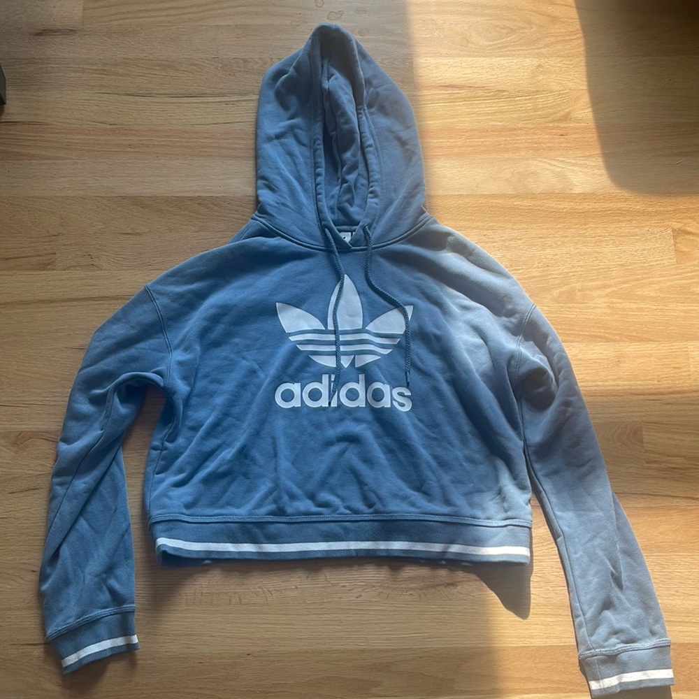 a blue adidas sweatshirt in a size small.